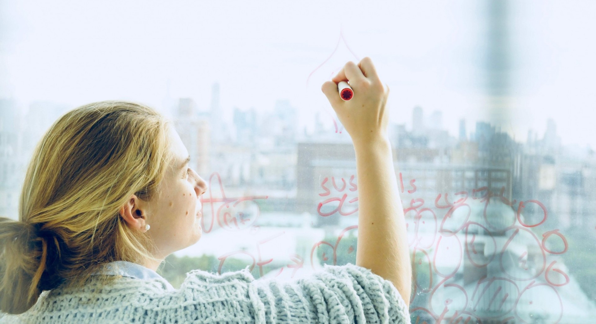 A researcher in the lab draws an olfactory sensory neuron on a windowpane