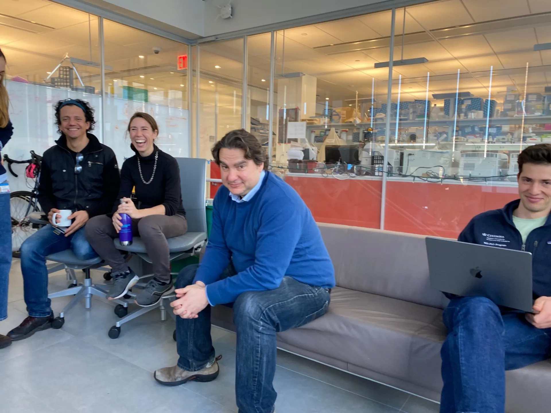 Martin and Rachel are all smiles.  Stavros is wearing a blue sweater and looks content.  Tibby peeks up to smile while attending his med school class. 