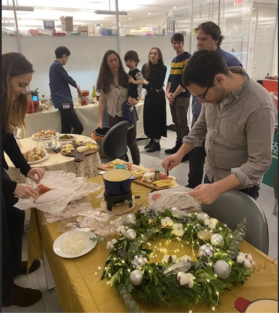 Albana and Hani lay food out while a hungry group gathers.