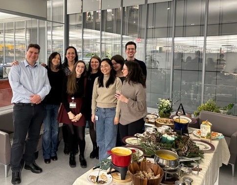 Group gathering behind a decorated table with fondue pots and woodland decorations