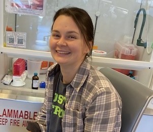 Isabella in front of the chemical hood 