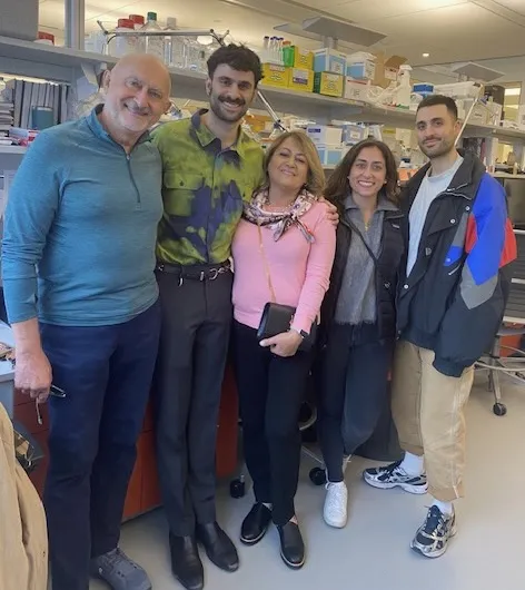 a group standing in front of a lab bench 