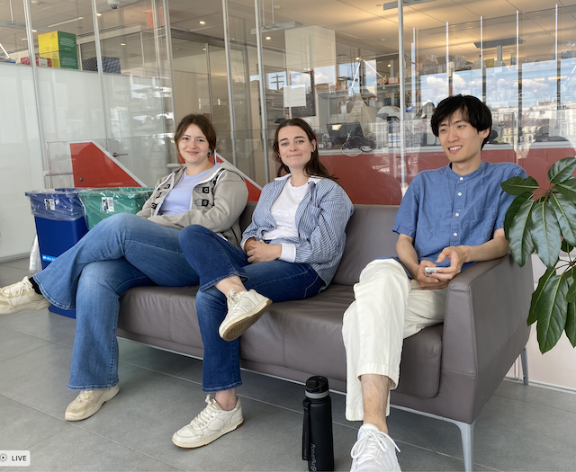 three students hanging out on a couch