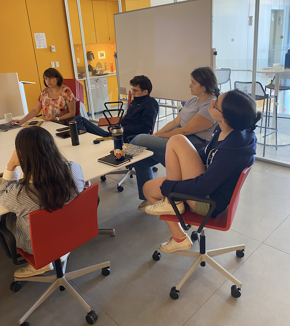 Lab group in a discussion at a table