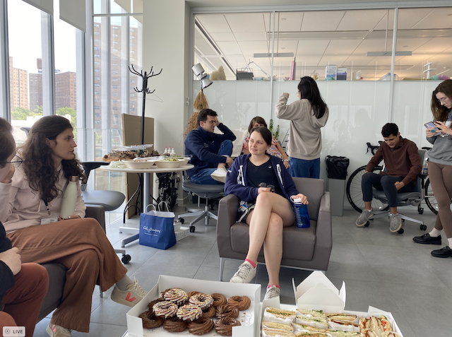 a group of students interacting throughout a room