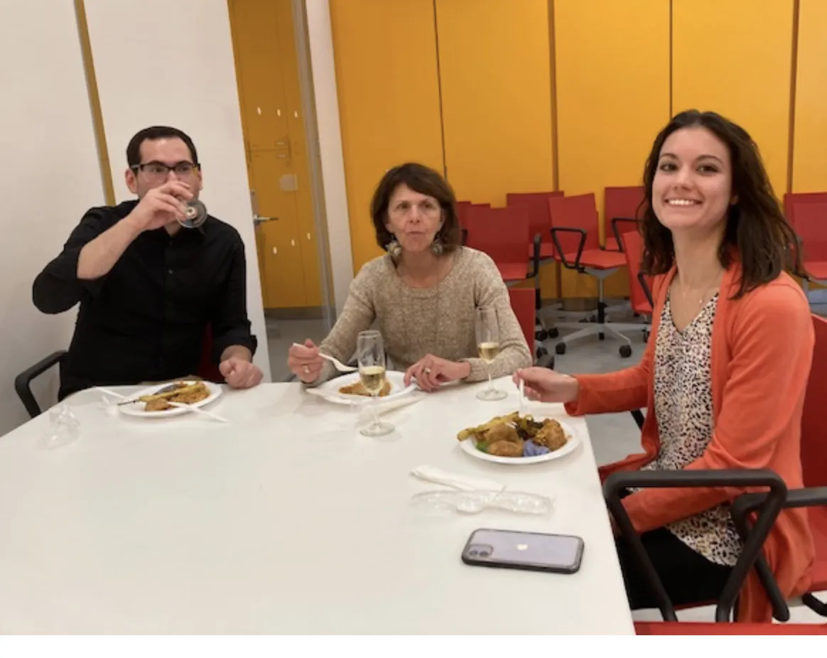 Hani is drinking champagne while Susan and Emily eat. 