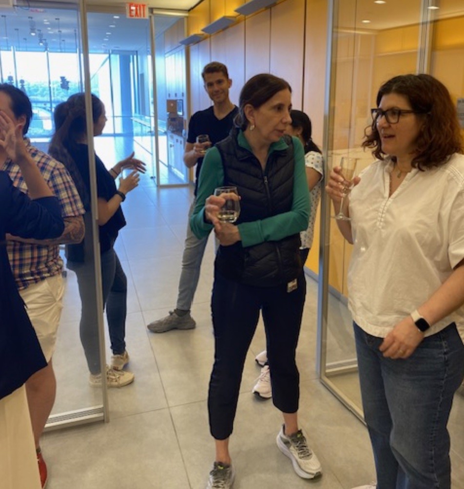 a group celebrating in a glass room 