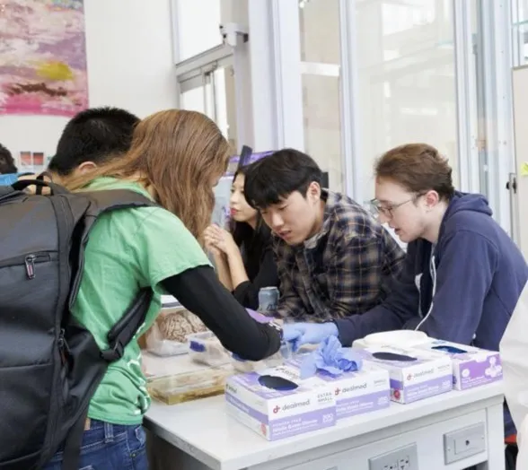 Trainees and community members interact at a monthly Saturday Science event hosted by ZMBBI. Photo credit: Sirin Samman