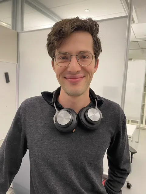 A portrait of a graduate student smiling.